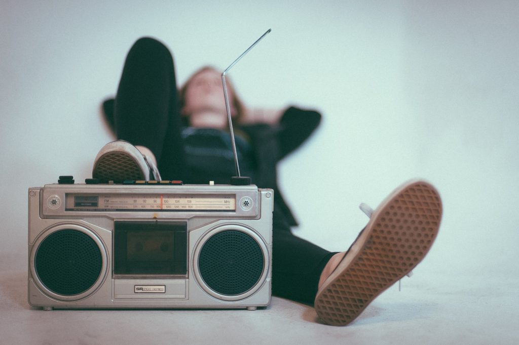 A young man listening to a radio