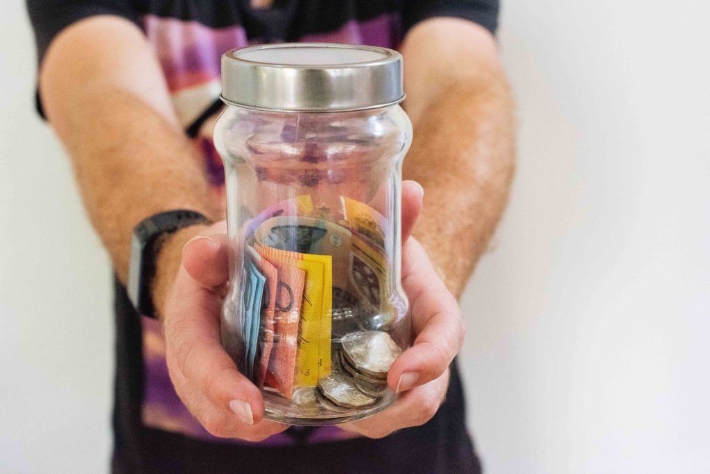 A glass jar holding some savings