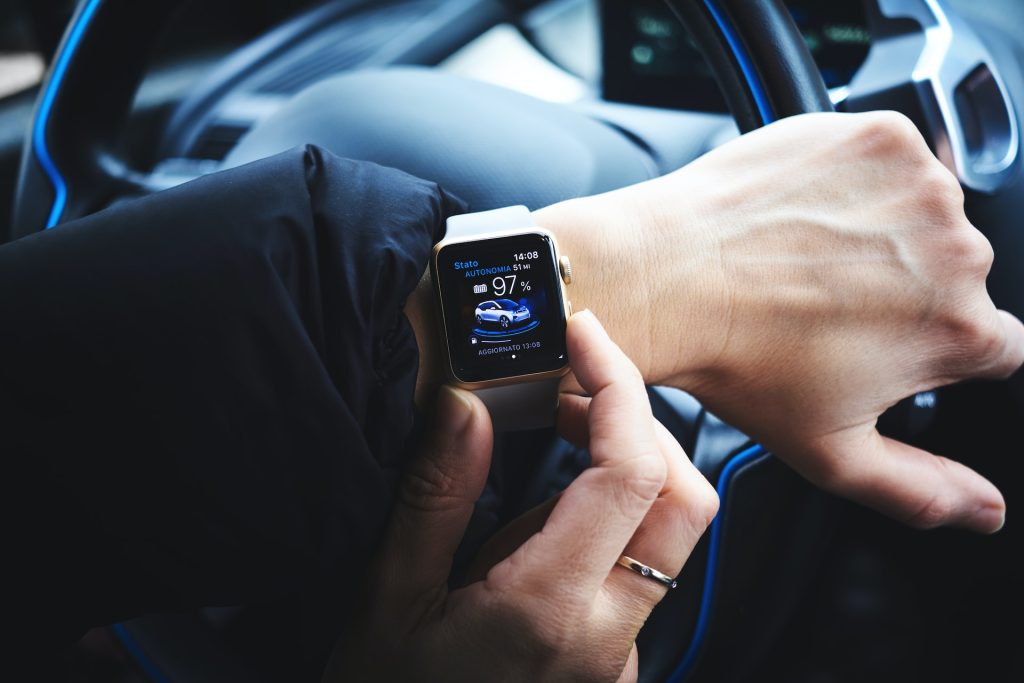 A person driving wearing an apple watch