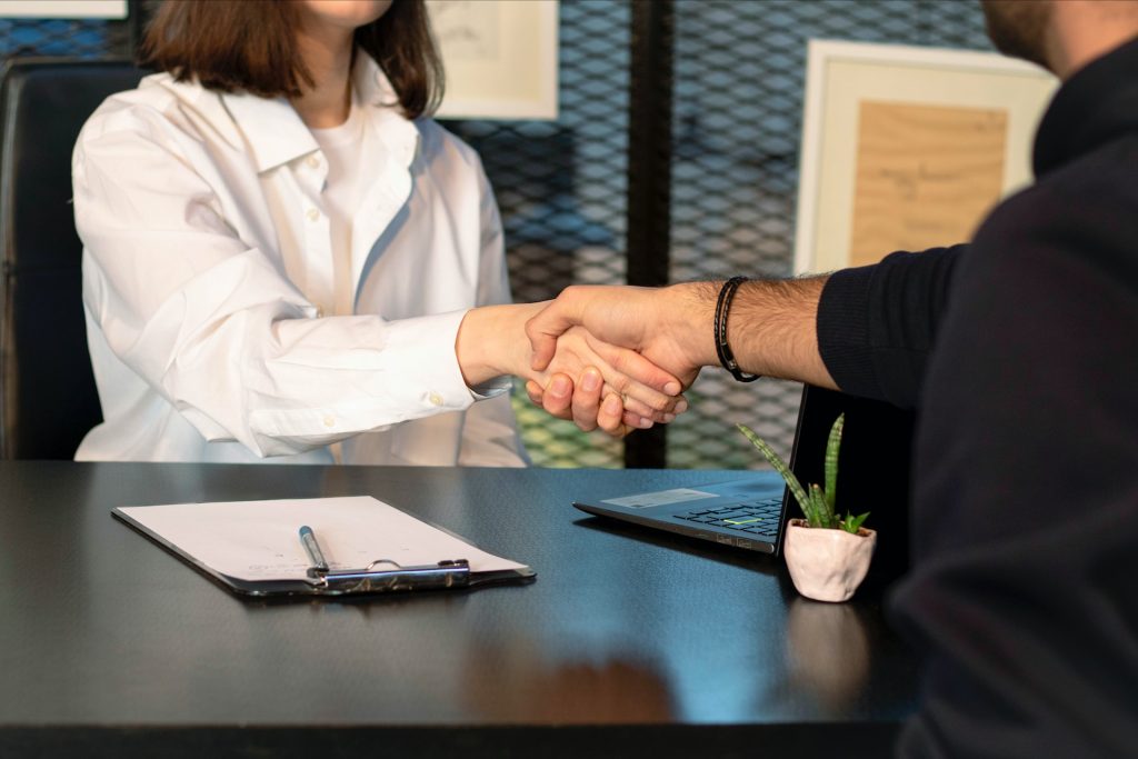 An employer and employee shaking hands