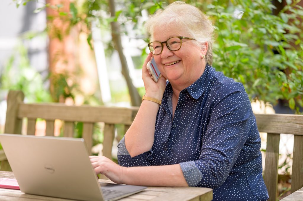 A retired woman working remotely