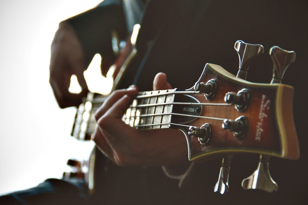 A person learning how to play guitar