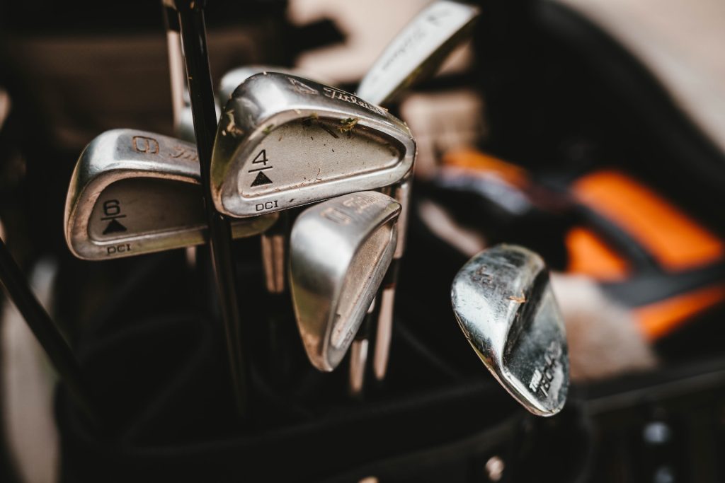 A collection of used golf clubs