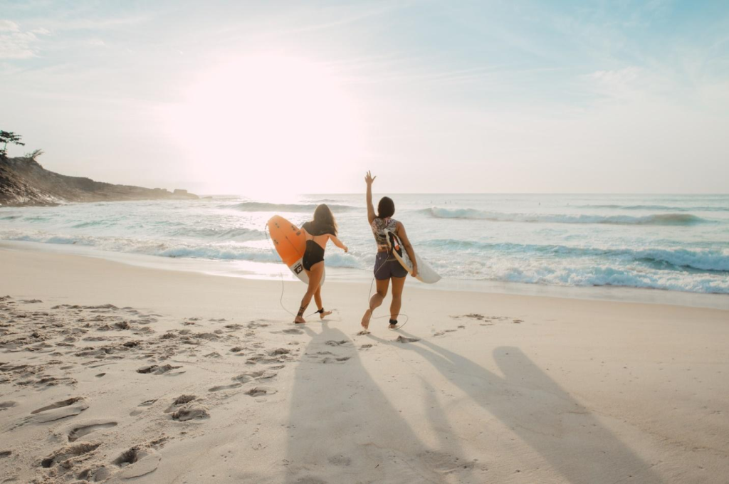 Two amateur surfer heading into the sea