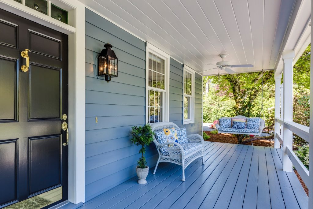 A porch with two chairs