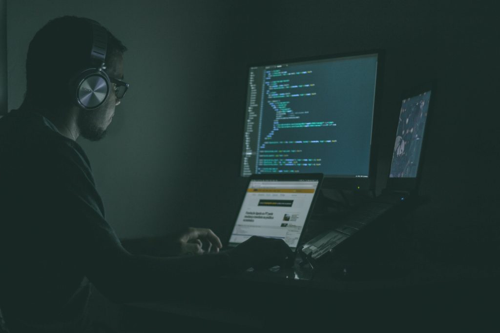 A person coding on a laptop