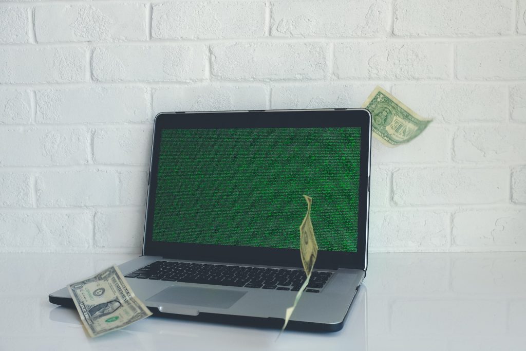 A laptop and money, signifying making money online