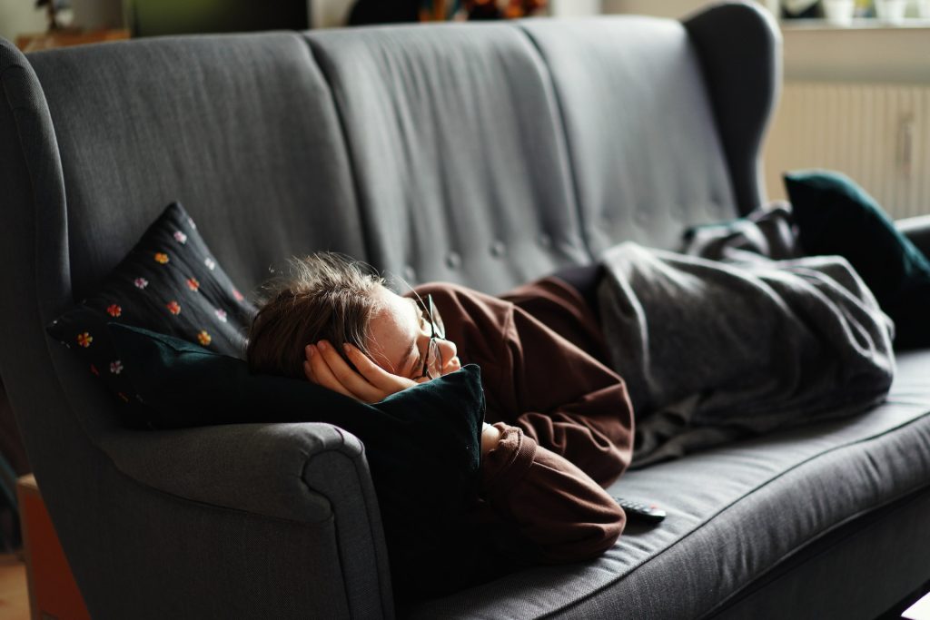 A person sleeping on a couch